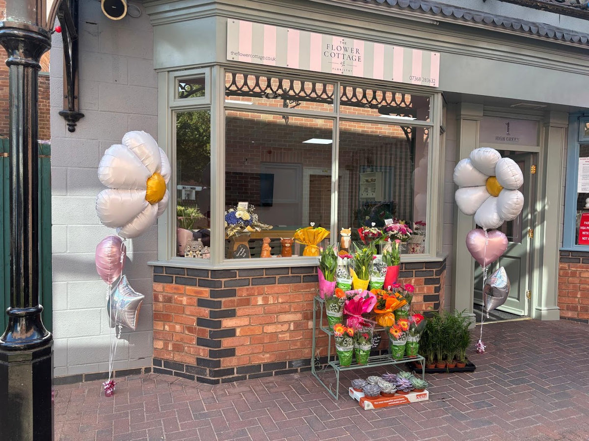 The Flower Cottage shopfront at 1 High Green Court, Cannock, with flowers displayed outside